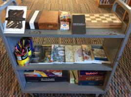 Coloring books and games on a library book cart